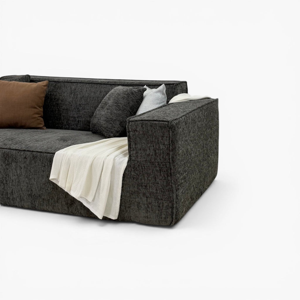Furnology Blocco dark grey textured fabric 3 seater sofa with memory foam, brown and grey cushions, and white throw.