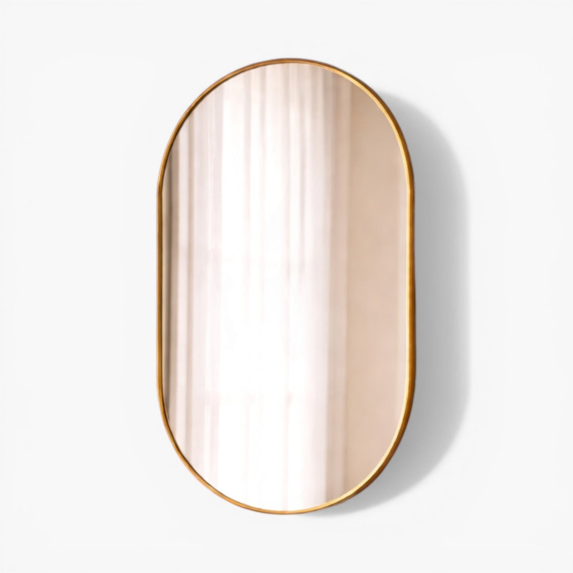 Furnology Lore Wall Mirror, oval shape with thin gold metal frame, modern minimalist design.